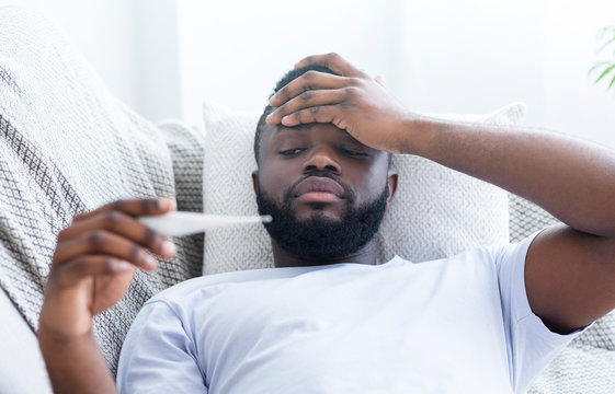 A man testing his temperature for malaria