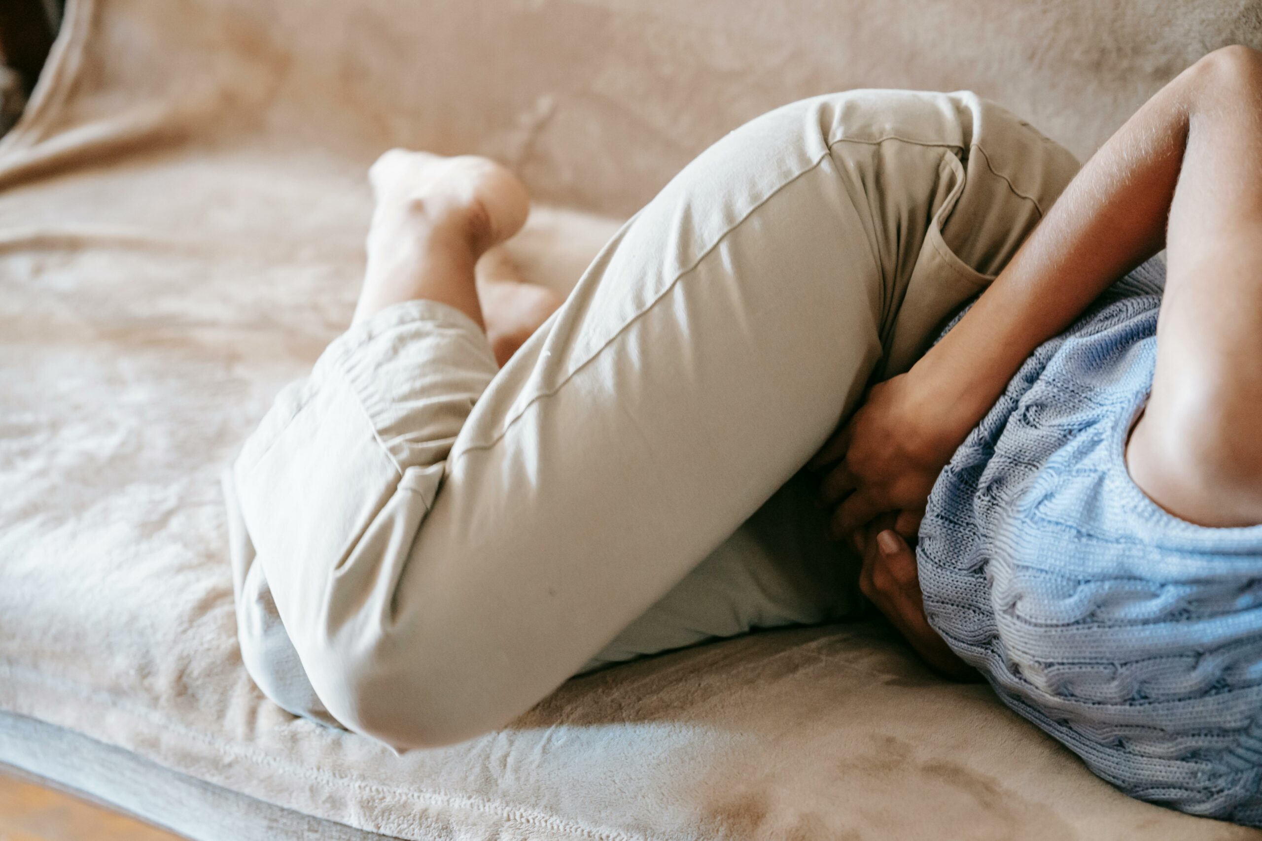 Young woman experiencing pain from toilet infection in Nigeria