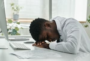 Tired young adult experiencing symptoms linked to vitamin deficiency in Nigeria.