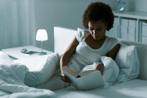 Sleep Deprivation and Your Health: Effects of Lack of Sleep + How to Sleep Better Black adult following a healthy bedtime routine before sleeping.