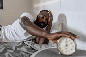 Nigerian professional looking tired after a poor night's sleep.